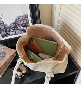 Internal view of a large white tote bag showing storage space for tablet and umbrella