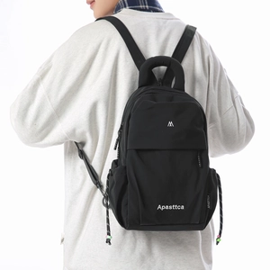Side view of a black lightweight fashion backpack with brand logo and drawstring side pockets