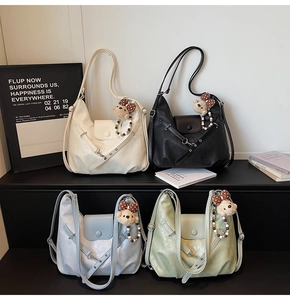 Macro shot of stylish tote bags in four pastel colors with cute teddy bear charms