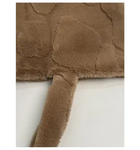 Detail showing the thick brown plush fabric and soft texture of the tote bag
