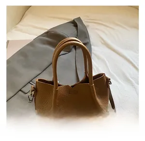 Detailed macro view of the brown lychee-pattern leather texture and silver hardware