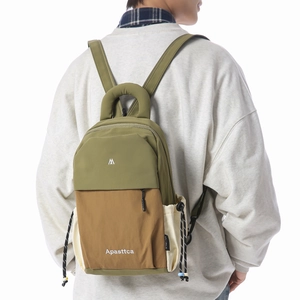 Detail view of stylish olive green backpack with drawstrings and logo for travel