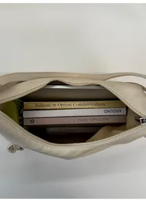 Top view of beige tote bag interior showing large capacity for laptop and books