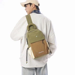 Detailed back view of a nylon color-block backpack with adjustable straps and side pocket
