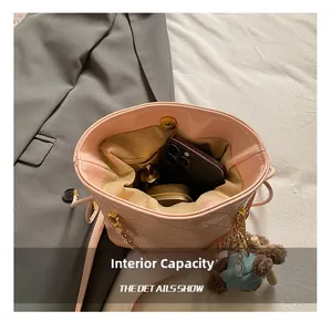 Top view of pink quilted bucket bag interior showing capacity for phone and cosmetics