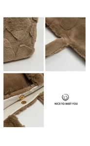 Detail view of brown plush tote bag with heart quilting and golden magnetic snap closure