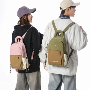 Detail view of water-resistant nylon backpacks with side drawstring pockets and logo
