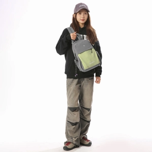 Close-up of the stylish grey and lime green contrasting sling bag worn by a model