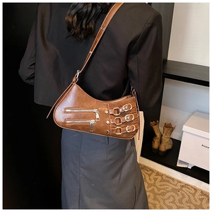 Detail view of vintage brown PU leather bag with zip pockets and buckle straps