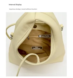 Detailed interior view of the cream shoulder bag showing the main pocket and zipper pouch