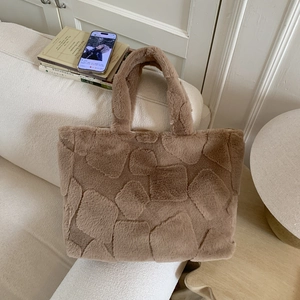 Detailed macro view of camel faux fur tote bag with geometric square textured patterns