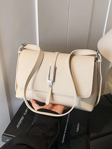 Minimalist beige small square crossbody bag with lychee texture and silver metal hardware