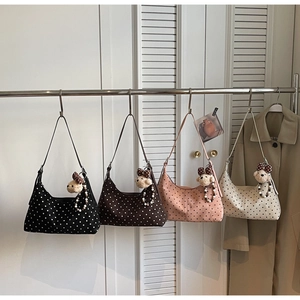 Polka dot hobo bags in four colors hanging with a cute plush bear charm detail