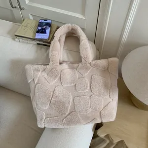 Detail of plush tote bag showing geometric 3D pattern and soft faux fur texture