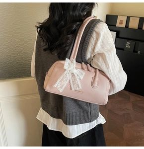 Close-up of pink Boston bag with lace bow decoration and Haven & Chic brand logo
