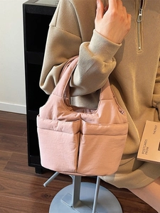 Pink quilted bucket tote bag with large external pockets and lightweight nylon fabric