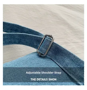 Close-up of adjustable denim shoulder strap with silver buckle on small crossbody bag
