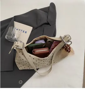 Detailed interior view of a polka dot shoulder bag showing large capacity for essentials