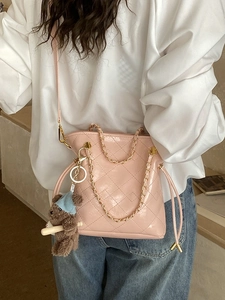 Pink quilted chain bucket bag for women with plush bear charm and crossbody strap