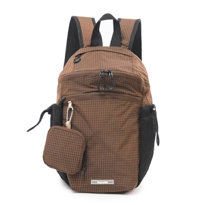 Detail of brown plaid nylon backpack featuring side mesh pocket and detachable small coin purse