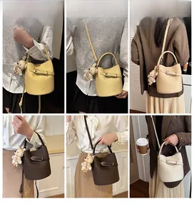 Litchi pattern bucket bag in four colors with stripe-shirt bear charm and metal buckle