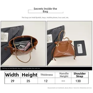 Sac seau matelassé marron avec guide des tailles et détails de la bandoulière en chaîne