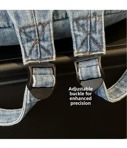 Detail of blue denim backpack showing adjustable plastic buckle and orange stitching