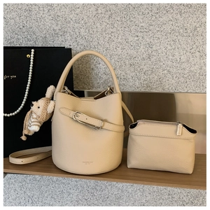 Beige leather bucket bag with inner pouch, litchi texture and metal buckle detail