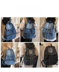 Detail view of retro denim backpacks in blue and black with drawstring and flap closure
