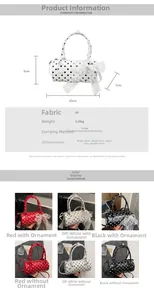 Detailed close-up of polka dot cylindrical handbag showing lace bow and pearl charm