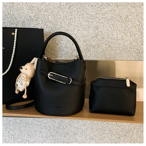 Detail of black lychee grain leather bucket bag set with matching inner pouch and accessories