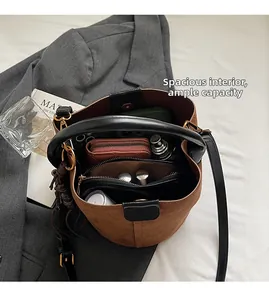 Interior detail of brown suede bucket bag showing large capacity for phone and wallet