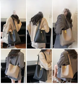 Détails du sac seau en cuir avec texture litchi et fermoir pivotant en métal doré
