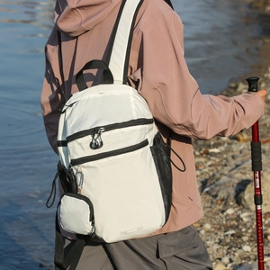 Detail of tear-resistant nylon backpack with plaid texture and hanging coin pouch