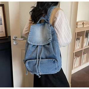 Classic blue denim backpack with drawstring closure and large front zip pocket