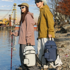 Detail view of lightweight checkered nylon backpacks with side mesh pockets and carabiner hook