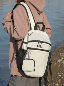 Waterproof white nylon backpack with black zipper details and detachable small pouch