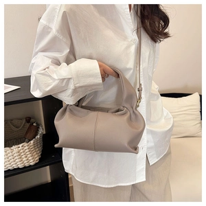 Detail of light purple pleated cloud bag showing soft leather texture and handle design