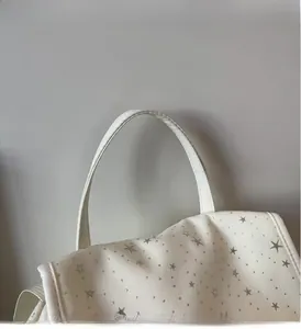 Close-up of durable canvas backpack handle with grey star print and woven texture