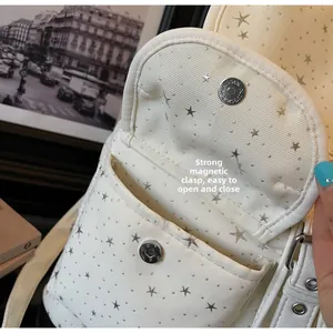 Detail of the magnetic buckle on star pattern canvas backpack with vintage silver hardware