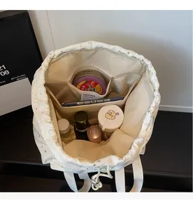 Interior view of white drawstring backpack showing storage space and inner pockets