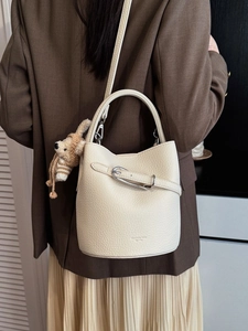Elegant off-white lychee texture bucket bag with bear charm and silver buckle strap