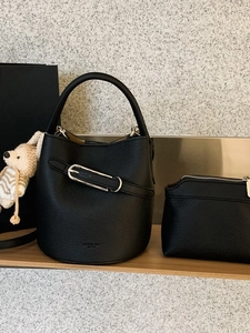 Litchi pattern black bucket bag with silver hardware and a small bear pendant