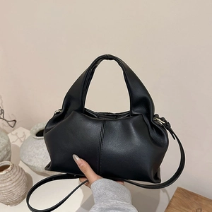 Fashionable black cloud handbag with top handle and slim shoulder strap for women