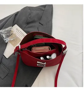 Top view of red leather bucket bag showing spacious interior with stylish accessories