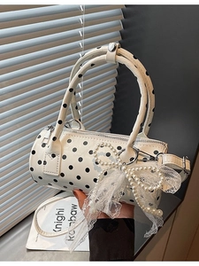 Chic white polka dot cylinder handbag with pearl bow charm and lace detail strap