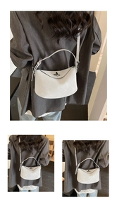 Detail of light grey half-moon crossbody bag with matte leather and metal twist lock