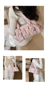Detail of pink pleated underarm bag with decorative metal buckles and sweet bow ribbons
