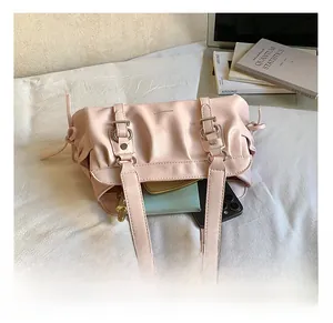 Detail view of pink pleated shoulder bag interior showing capacity for phone and wallet