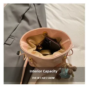 Macro view of pink quilted leather bucket bag interior showing spacious storage capacity